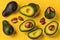 Fresh delicate avocado slices on yellow background