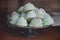 Fresh delicious colored meringue cookies covered with chocolate powder
