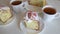 fresh delicious Easter cake on the background of a table and cups of tea.