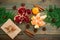 Fresh delicious garnet, citrus, cinnamon and craft gift box on wooden background. New year concept. Flat lay. Top view