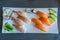 Fresh and delicious nigiri sushi on well-decorated square white plate