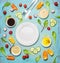 Fresh delicious salad and dressing ingredients around empty white plate on light blue background, top view, frame. Health salad ma