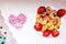 Fresh and delicious strawberries with cream cookies and poppy seeds on a rustic table with a pink heart on Valentine`s Day