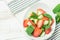 Fresh Detox Summer Spring Salad with Strawberries Green Mint Leaves in White Ceramic Bowl on Cotton Kitchen Towel