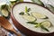 Fresh diet cucumber cream soup with mint close up in a bowl. horizontal