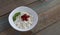 Fresh diet curd homemade in a white plate with ripe strawberries and mint leaf on wooden background from boards. healthy breakfast