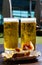 Fresh draught lager or IPA beer is glass served in outdoor cafe close up, pint of beer close up