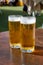 Fresh draught lager or IPA beer is glass served in outdoor cafe close up, pint of beer close up