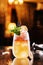 Fresh drink with lemon, orange and ice in glass jar on backdrop of the restaurant atmosphere. Summer drinks and cocktails