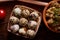 Fresh eggs of a quail with tomato and bowl of paste on wooden table, selective focus, close-up