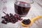 Fresh elderberry with wooden spoon and juice on old wooden background, healthy nutrition