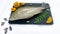 Fresh Emperor Fish decorated with herbs and vegetables on a black pad.White Background