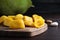 Fresh exotic jackfruit bulbs on black wooden table, closeup