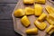 Fresh exotic jackfruit bulbs on black wooden table, flat lay