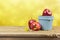 Fresh farm apples on wooden table over yellow bokeh background