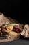 Fresh farm cheese and mini salami with walnuts, craft on paper. Food for wine, ready to eat. dark key photography, copy space