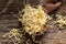 Fresh fenugreek sprouts on a wooden spoon