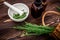 Fresh Field horsetail in a pharmacy mortar with a pestle on a wooden table. Collection of medicinal herbs for homeopathy and