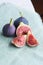 Fresh figs on a pastel linen fabric background. Vegetarian Food.