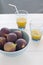 Fresh figs in turquoise bowl with orange juice