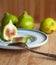 Fresh figs on a wooden board with a white plate and a vintage de