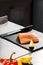 Fresh fish fillet at kitchen table. Closeup salmon at restaurant kitchen.