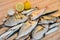 Fresh fish with lemon ready for cooking. Preparing delicious and tasty seafood meal. Uncooked Gilt-head sea bream, Sardines, Commo