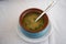 Fresh fish soup in bowl on white background, top view