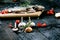 Fresh fish on a vintage black, burnt table. Wooden table. Fish with vegetables, salt, oil, herbs. Concept of cooking. Healthy and