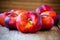 Fresh flat nectarines on a wooden background