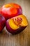 Fresh flat nectarines on a wooden background