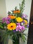 Fresh flower bouquet pink green leaves vase pansy marigold