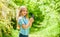 Fresh flowers. Collecting flowers in field. Summer is here. Kid hold flowers. Girl cute adorable teen nature background