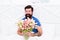 Fresh flowers surprise. Gift for spouse. Bearded hipster in bed. Spring mood in his bedroom. Man hold tulips bouquet