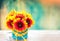 Fresh flowers in vase on wooden table. Vintage background.