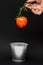 fresh flying tomatoes on a branch in the air. tomatoes in a tin bucket.  vegetarian food. fresh vegetables on a dark background.