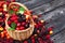 Fresh forest berries in basket on wooden background. Copy space