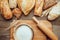 Fresh fragrant bread on the wooden table with cutting board and flour. Food concept