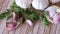 Fresh fragrant parsley sprigs and garlic cloves prepared for cooking on wooden table. Popular organic condiments used to