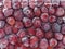 Fresh frozen fruits red plum in hoarfrost