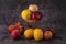 Fresh fruit apples and lemons on a glass vase on a marble table