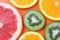 Fresh fruit background, citrus colorful pattern. Slice of kiwi, orange and grapefruit on bright background. Exotic tropical fruits