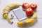 Fresh fruit: bananas and apples on a wooden table.