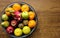 Fresh fruit basket containing dragon fruit, apples, kiwi, orange, pears, green apple, sweet lime