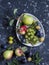 Fresh fruit - grapes, pears, apples, plums on a dark background
