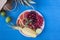 Fresh fruit plate on vivid blue background - pineapple, coconut, lime. Top view from above overhead. Tropical beach lifestyle