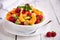 Fresh fruit salad with with raspberry, mandarin and other fruit