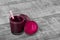 Fresh fruit smoothie with a straw. Blended beetroots on a table background. Liquid appetizers. Cut beets. Copy space.