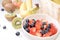 Fresh fruit, strawberries, berries, bananas, kiwis on a white background. Ingredients for a amoothie