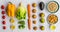 Fresh fruit and vegetables, grains, and nuts on a white background.